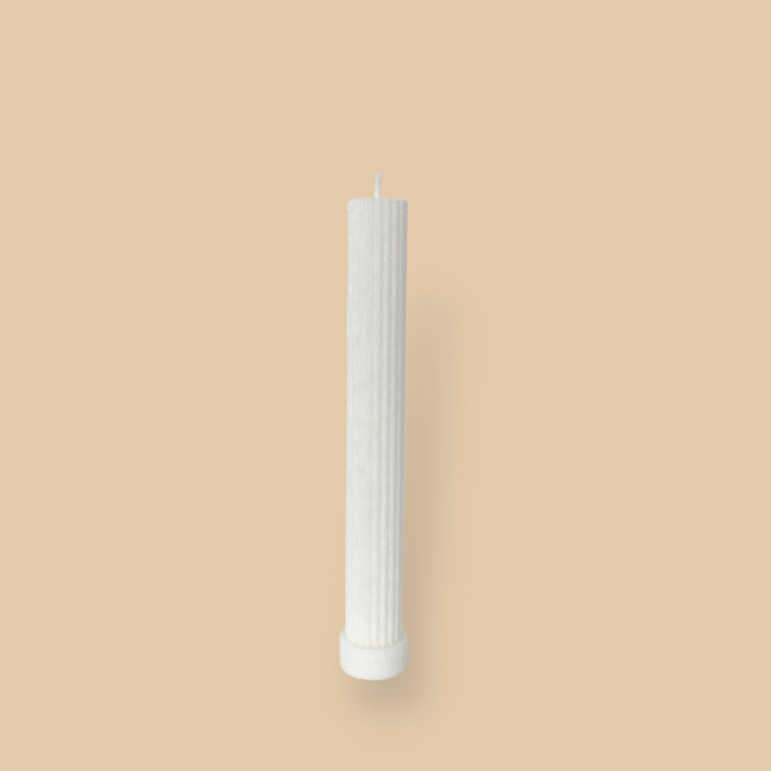 Allegra fluted pillar candle in 22cm height and flat base shown in ivory (white) colour.