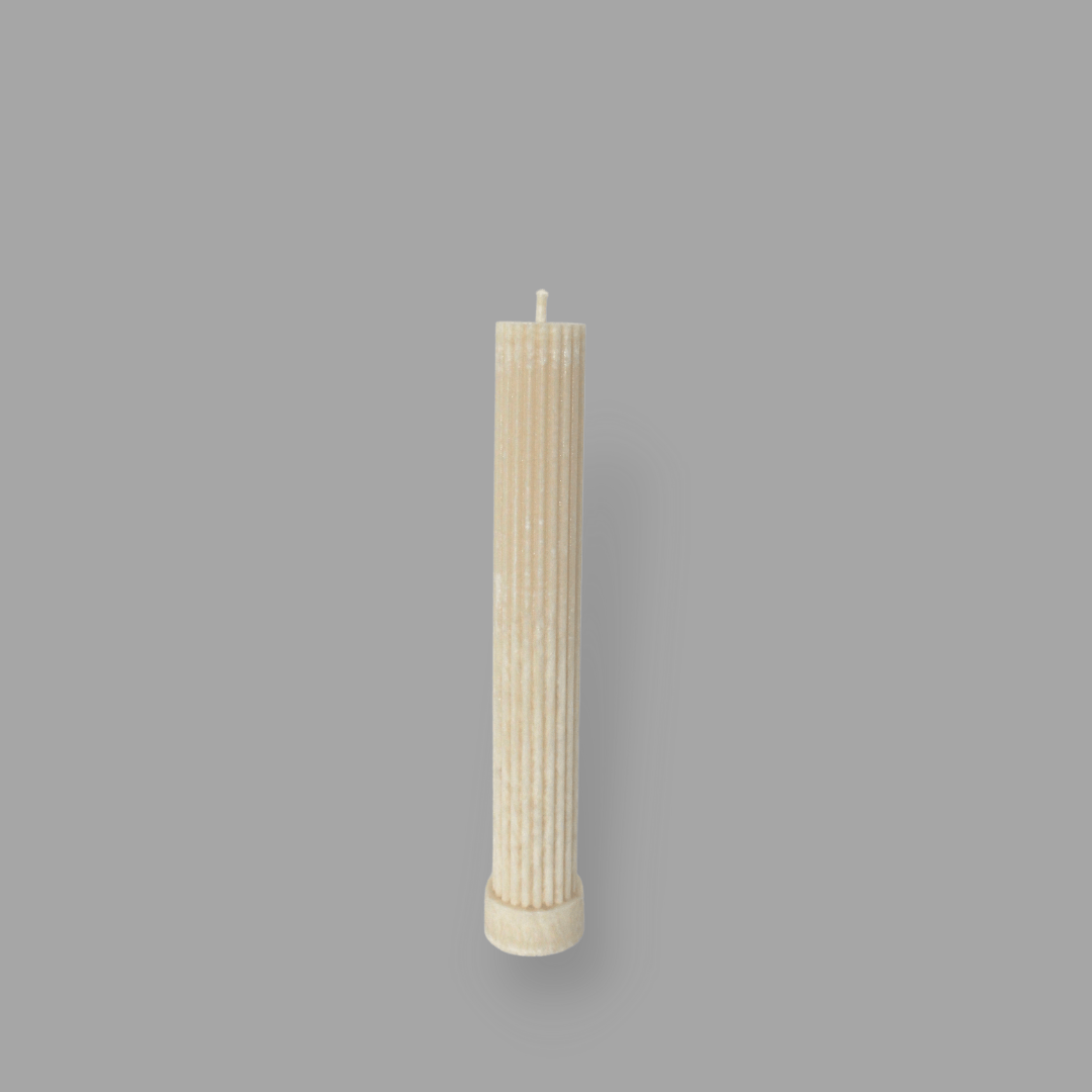 Allegra fluted pillar candle in 20cm height and flat base shown in White Onyx (warm cream) colour.