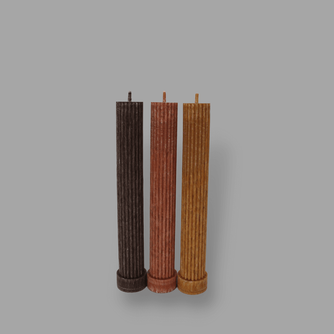 Allegra fluted pillar candle in 20cm height and flat base shown in Cacoa, Rust and Caramel colours.