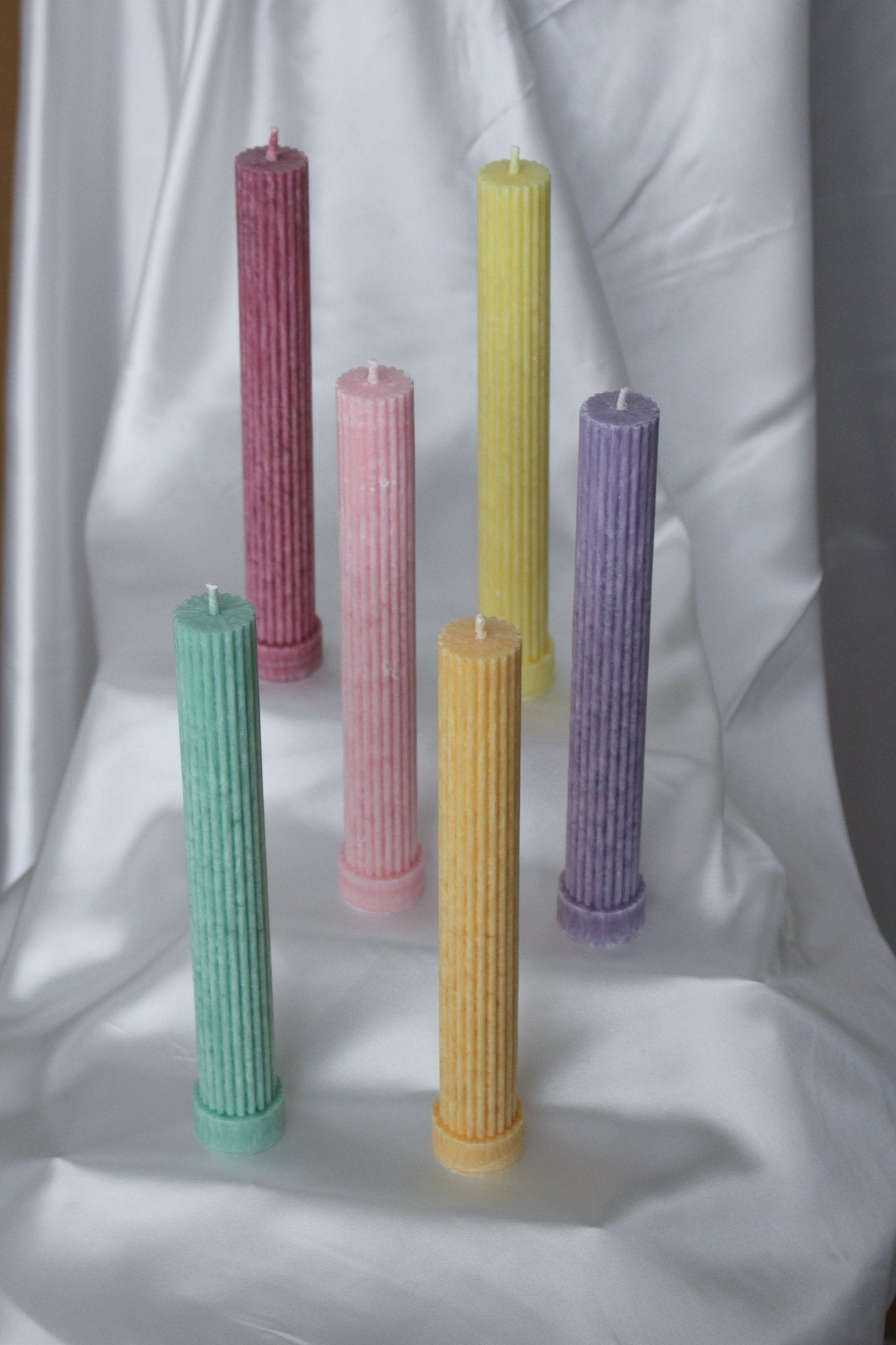 Allegra fluted pillar candle with flat base shown in all six bright pastel colours.