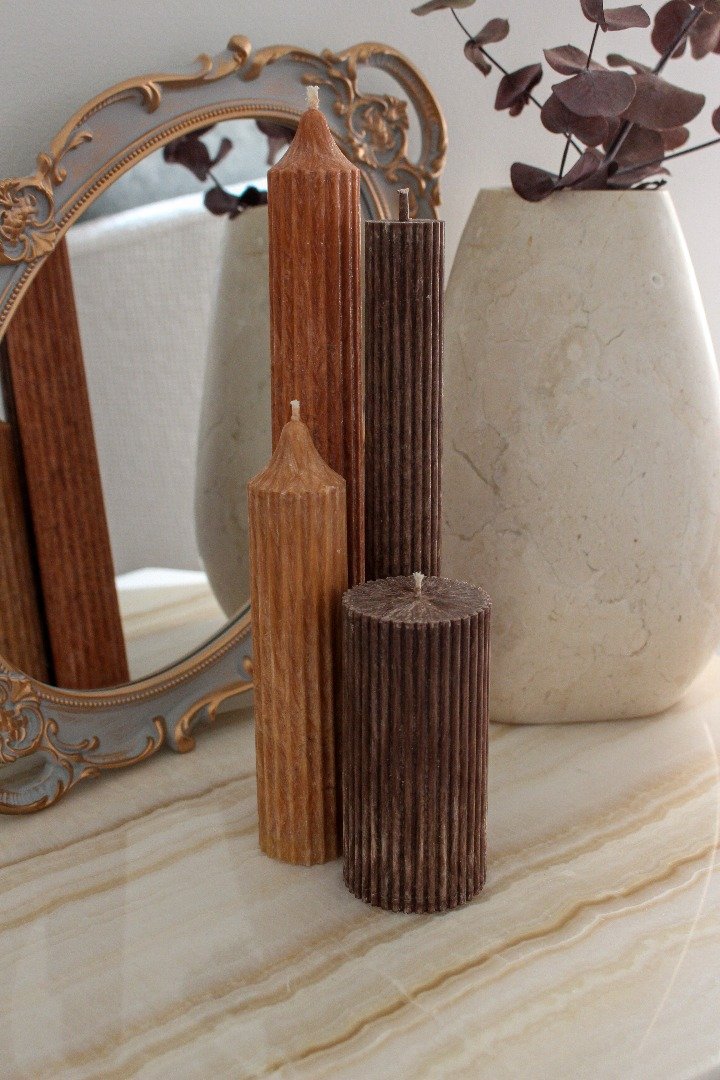 Arrangement of fluted candles including Allegra in a combination of Rust, Caramel and Cacao colours.