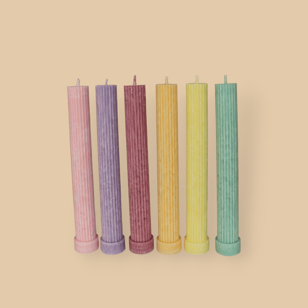 Allegra fluted pillar candle in 22cm height and flat base shown in six bright pastel colours.