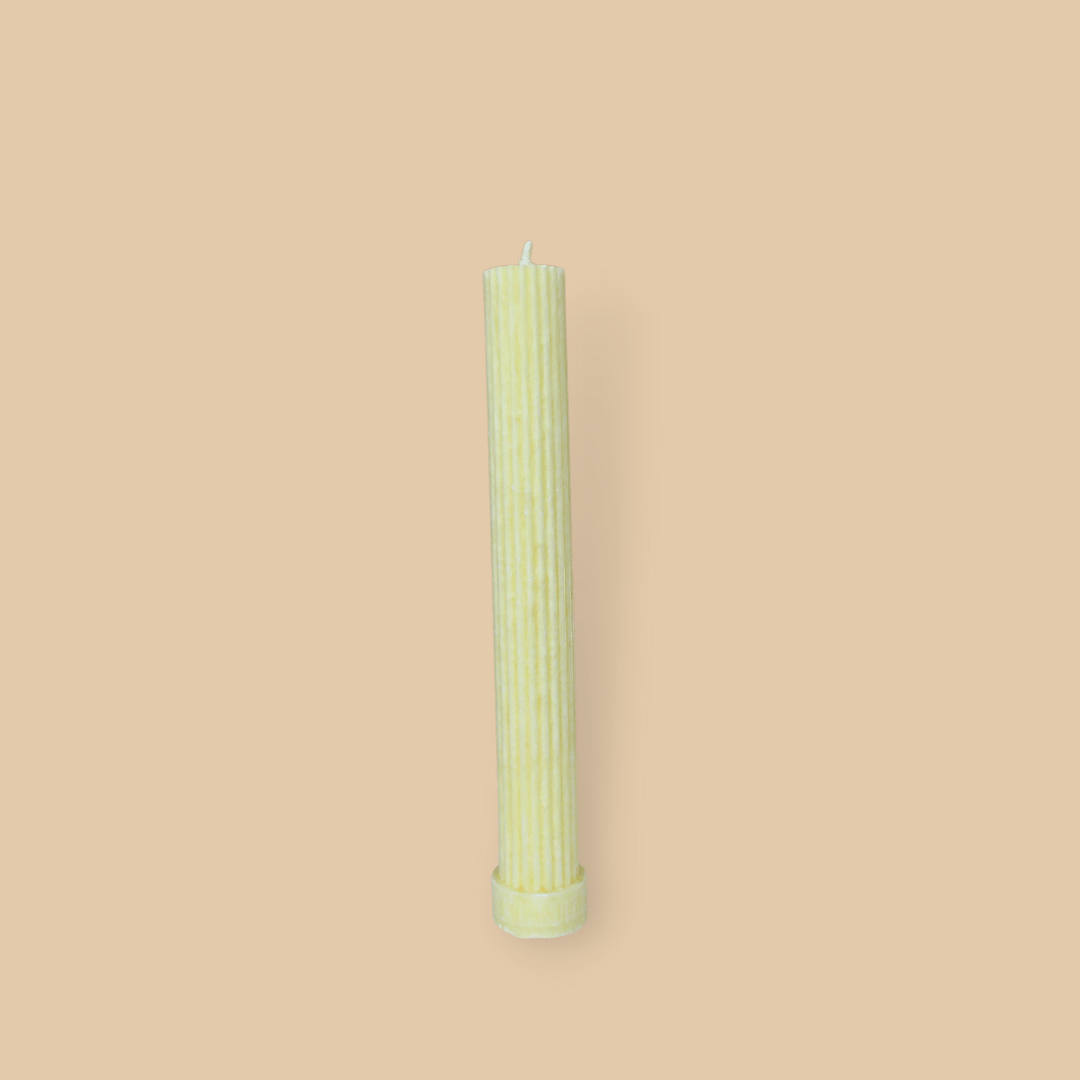 Allegra fluted pillar candle in 22cm height and flat base shown in frangipani (yellow) colour. 