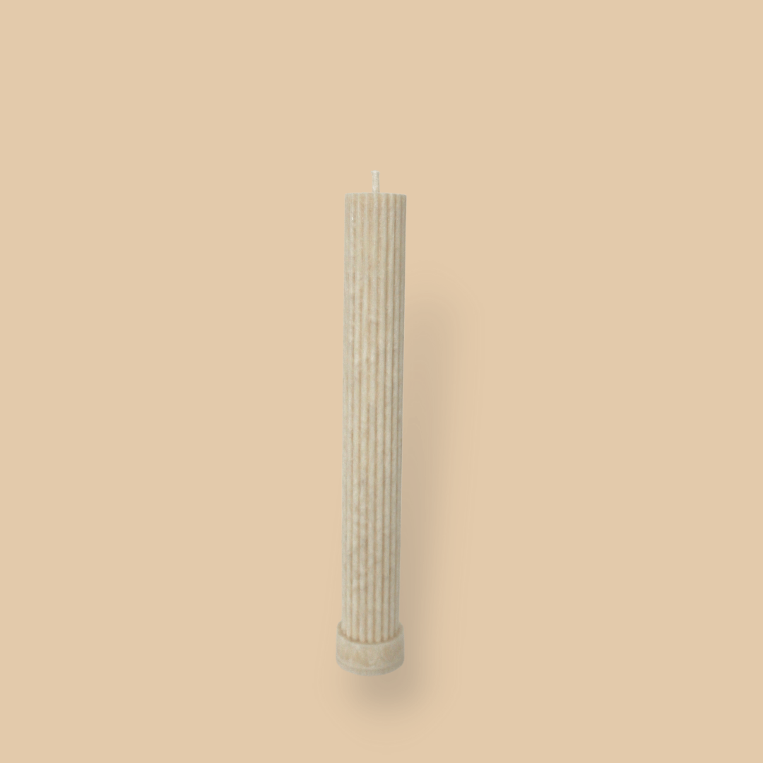 Allegra fluted pillar candle in 22cm height and flat base shown in White Onyx (warm cream) colour.