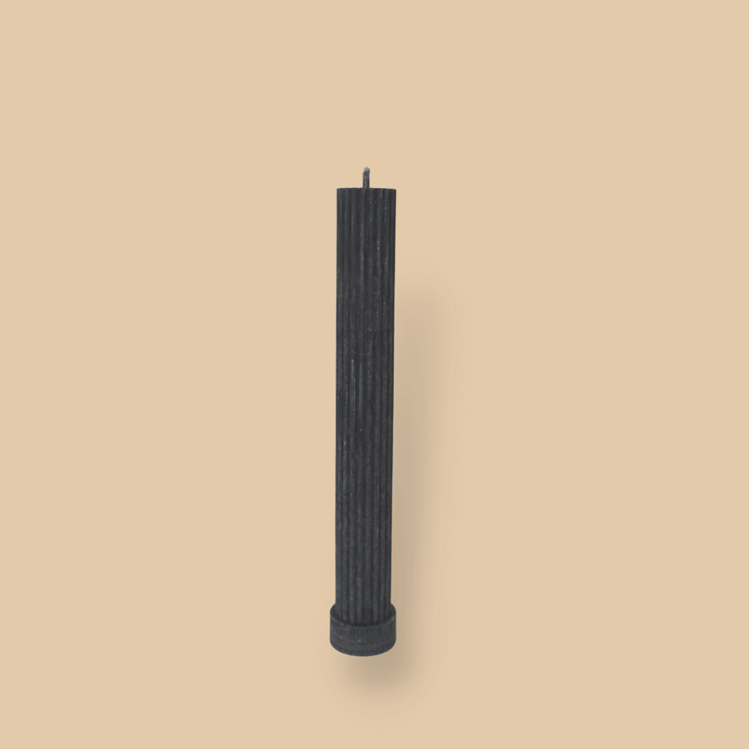 Allegra fluted pillar candle in 22cm height and flat base shown in New Moon (charcoal grey) colour.