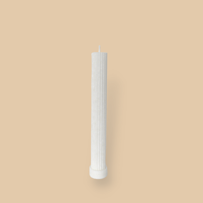 Allegra fluted pillar candle in 22cm height and flat base shown in ivory (white) colour. 