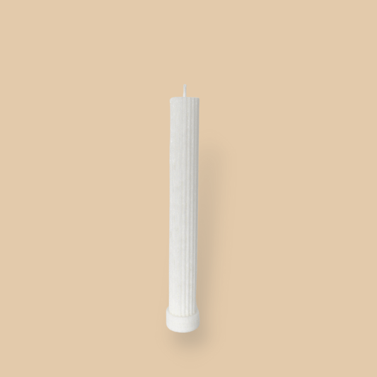 Allegra fluted pillar candle in 22cm height and flat base shown in ivory (white) colour. 