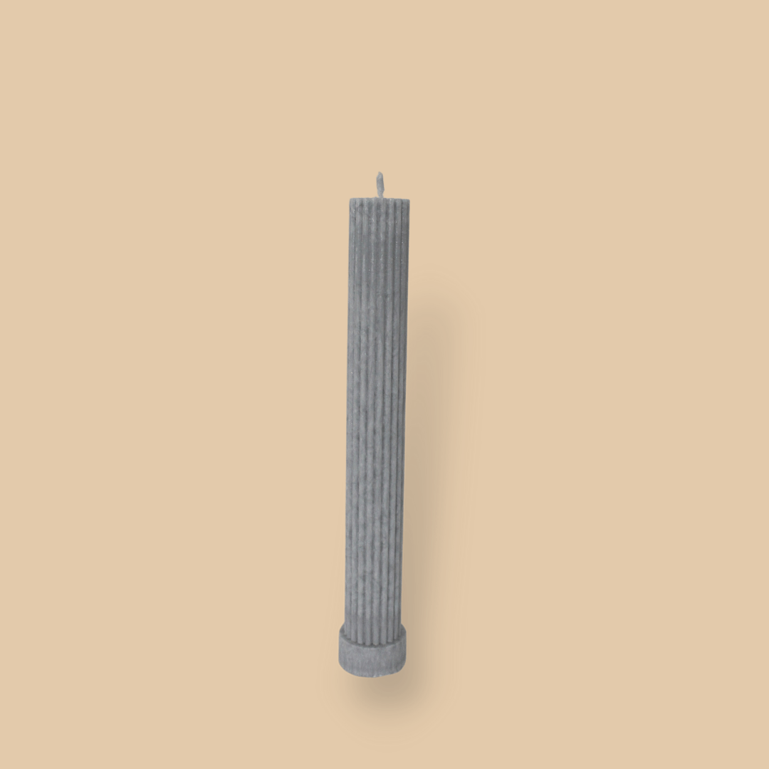 Allegra fluted pillar candle in 22cm height and flat base shown in Half Moon (light grey) colour.