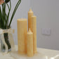 Arrangement of fluted pillar candles including Allegra all in Marigold (pastel orange) colour. This arrangement is the New Heights Bundle.