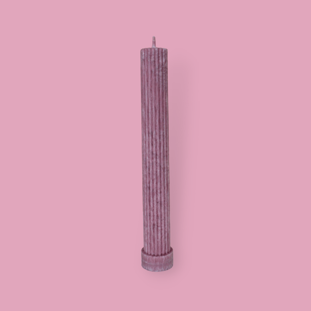 Allegra fluted pillar candle in 27cm height and flat base shown in Calla (pastel cherry) colour.