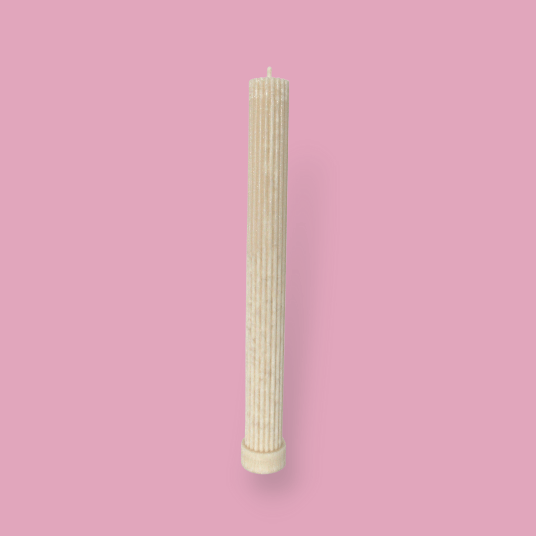 Allegra fluted pillar candle in 27cm height and flat base shown in White Onyx (warm cream) colour.