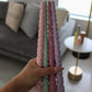 Twisty Ariel taper candles in Peony (pink), Bud (green), Calla (cherry) and Lavender (purple) shown together.