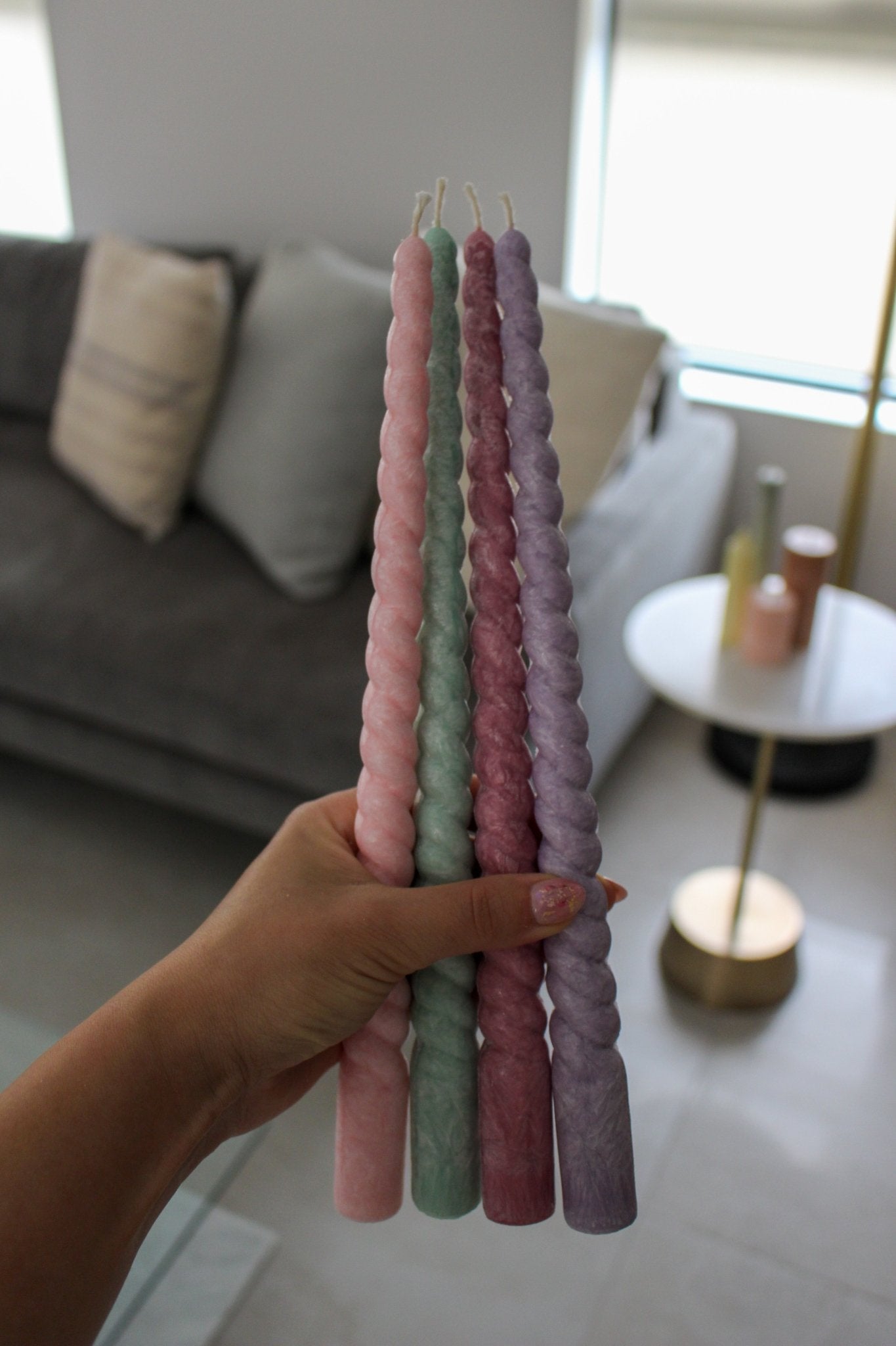 Twisty Ariel taper candles in Peony (pink), Bud (green), Calla (cherry) and Lavender (purple) shown together.