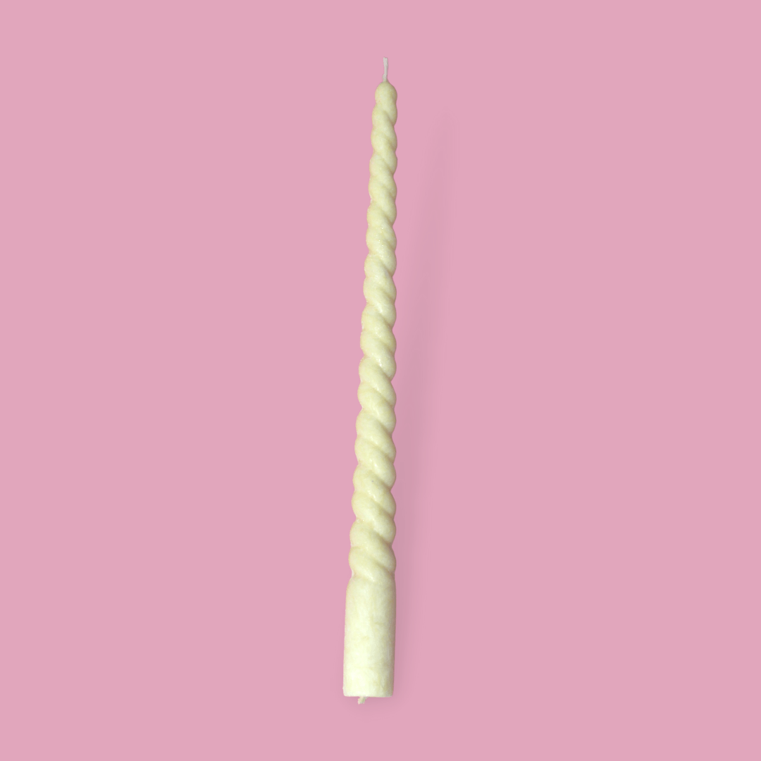 Twisty Ariel taper candle in Frangipani (pastel yellow) colour.