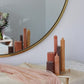 Arrangement of fluted pillar candles in warm neutral tones including tall Elia pillar candle in Caramel colour.