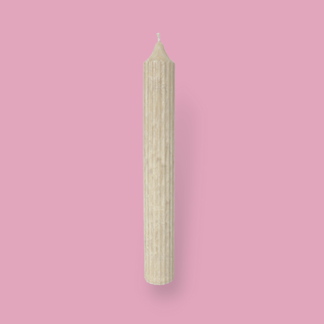 Tall pillar candle with a pointed top Elia in White Onyx (warm cream) colour.