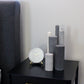 Arrangement of fluted pillar candles shown in grey shades.