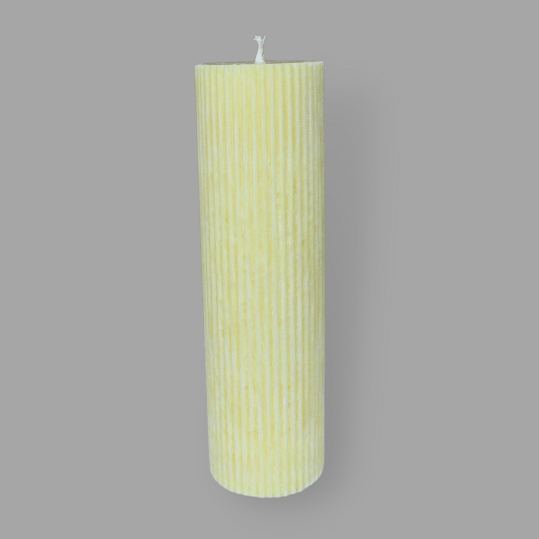 Tall thick fluted pillar candle Kaitlyn in Frangipani (pastel yellow) colour. This standalone pillar candle has a flat top and base.