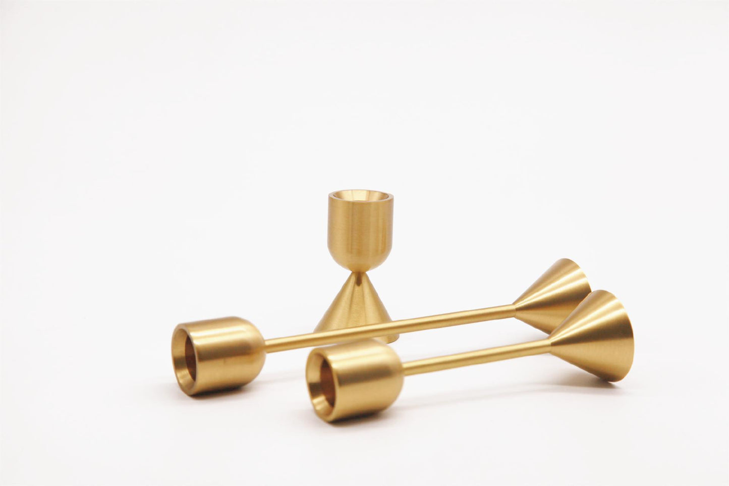 Two sided solid brass gold candlestick holders. Set of 3 holders shown.