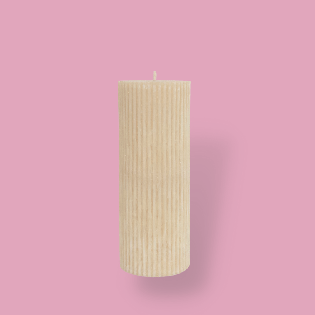 Medium height thick fluted pillar candle Marlie in White Onyx (warm cream) colour. This standalone pillar candle has a flat top and base.