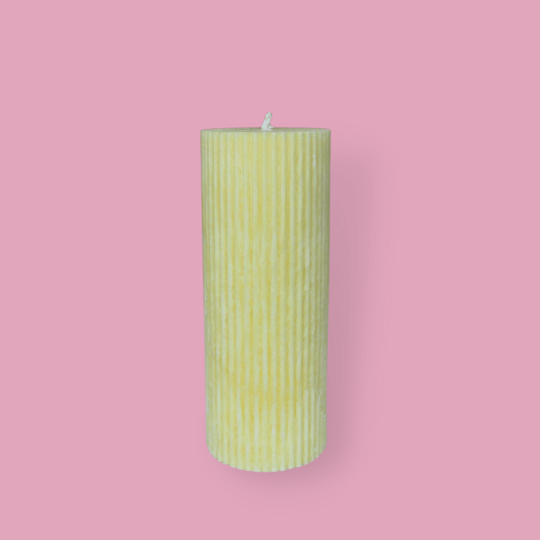 Medium height thick fluted pillar candle Marlie in Frangipani (pastel yellow) colour. This standalone pillar candle has a flat top and base.