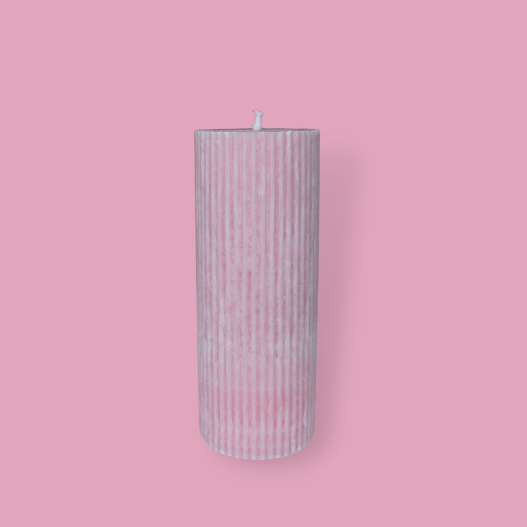 Medium height thick fluted pillar candle Marlie in Peony (pastel pink) colour. This standalone pillar candle has a flat top and base.