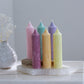 Fluted Mia pillar candles shown in pastel pink, green, lavender, cherry, orange and yellow colours.