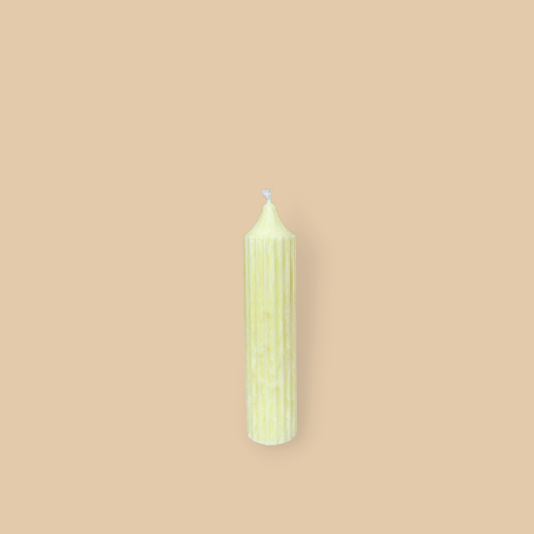 Pillar candle with a pointed top Mia in Frangipani (pastel yellow) colour.