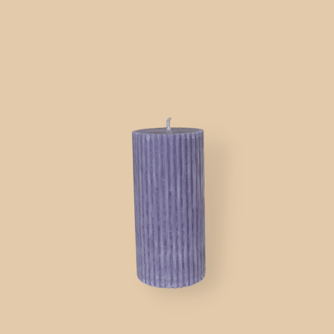 Short thick fluted pillar candle Sasha in Lavender (pastel purple) colour. This standalone pillar candle has a flat top and base.