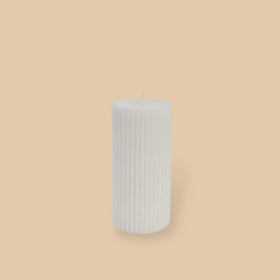 Short thick fluted pillar candle Sasha in Ivory (white) colour. This standalone pillar candle has a flat top and base.