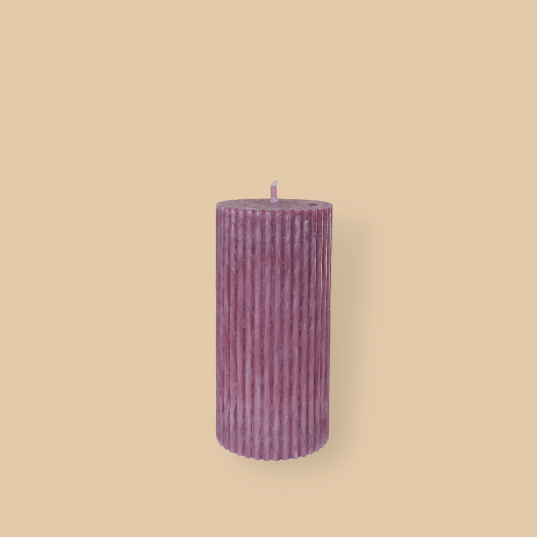 Short thick fluted pillar candle Sasha in Calla (pastel cherry) colour. This standalone pillar candle has a flat top and base.