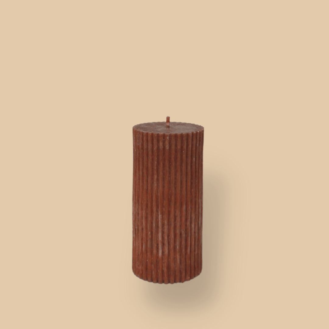 Short thick fluted pillar candle Sasha in Rust (burnt orange)colour. This standalone pillar candle has a flat top and base.