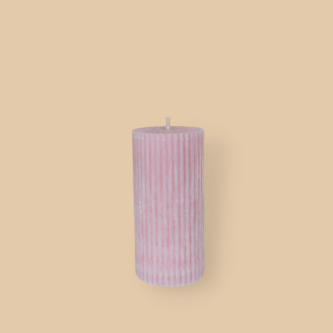 Short thick fluted pillar candle Sasha in Peony (pastel pink) colour. This standalone pillar candle has a flat top and base.