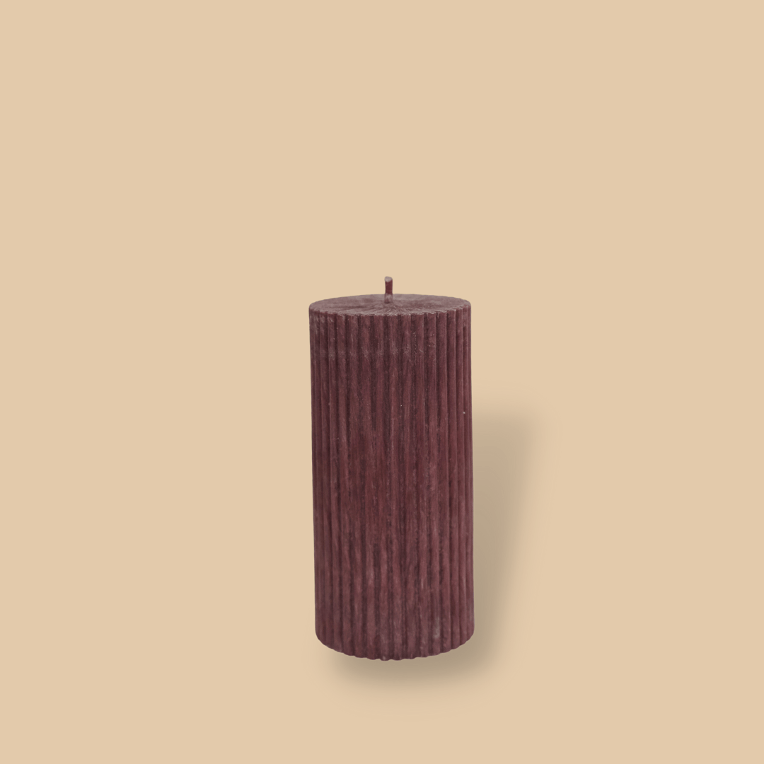 Short thick fluted pillar candle Sasha in Viola (wine) colour. This standalone pillar candle has a flat top and base.