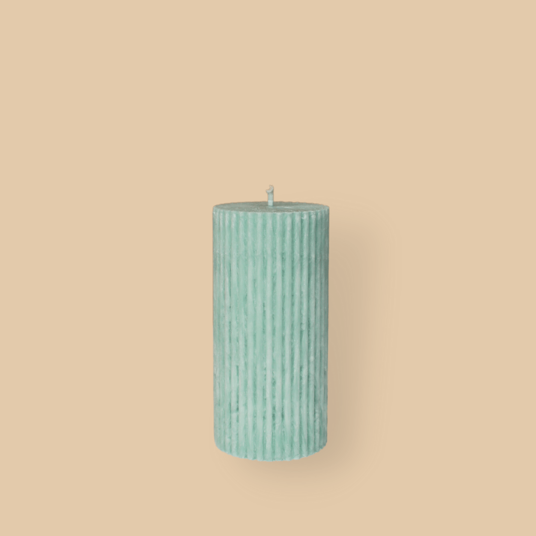 Short thick fluted pillar candle Sasha in Bud (pastel green) colour. This standalone pillar candle has a flat top and base.