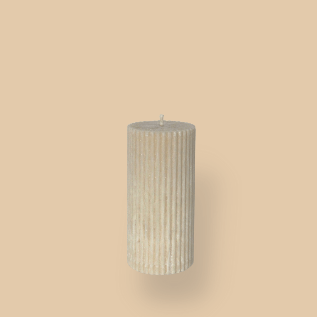 Short thick fluted pillar candle Sasha in White Onyx (warm cream) colour. This standalone pillar candle has a flat top and base.